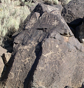 [This rock has what appears to be lizard symbols on it in multiple places.]